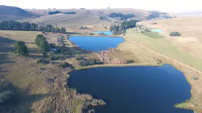 an aerial view of a lake in a field at Elandskloof Trout Farm in Dullstroom