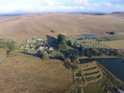 an aerial view of a farm with a lake at Elandskloof Trout Farm in Dullstroom