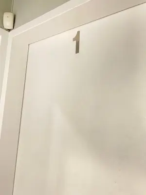 a white door with the number one on it at Ranx Guest House in Pretoria