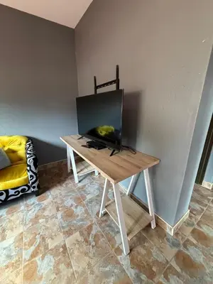 a table with a television on it in a room at Royal nest Sibasa in Thohoyandou