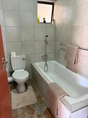 a bathroom with a toilet and a bath tub with at Royal nest Sibasa in Thohoyandou