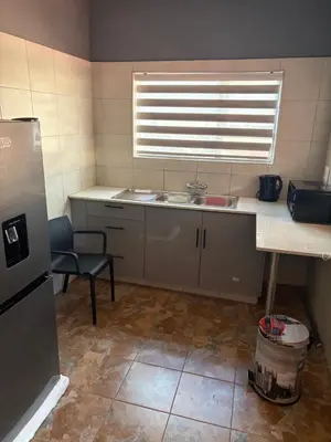 a small kitchen with a sink and a window at Royal nest Sibasa in Thohoyandou