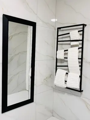 a mirror in a bathroom with white towels at Adilo Villa Midrand Hill of Good Hope 2 in Midrand