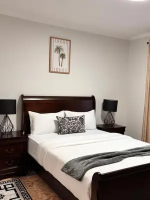 a bedroom with a large bed with two lamps at Adilo Villa Midrand Hill of Good Hope 2 in Midrand