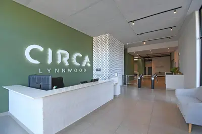 an office lobby with a sign on the wall at Charcoal Suite- Circa Lynnwood in Pretoria