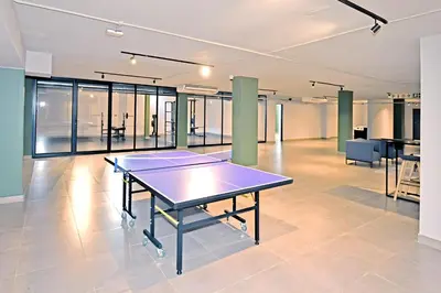 a ping pong table in the middle of a room at Charcoal Suite- Circa Lynnwood in Pretoria