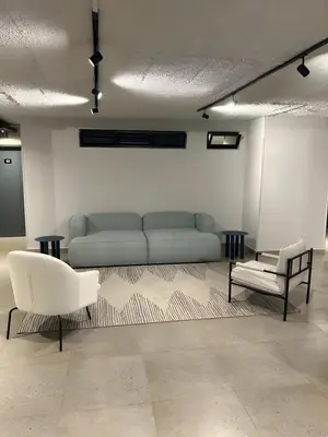 a living room with a couch and two chairs at Charcoal Suite- Circa Lynnwood in Pretoria