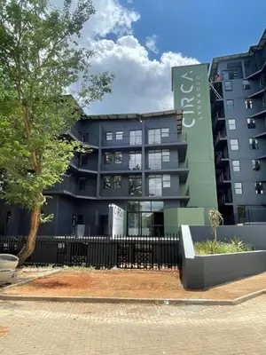 a building with a fence in front of it at Charcoal Suite- Circa Lynnwood in Pretoria