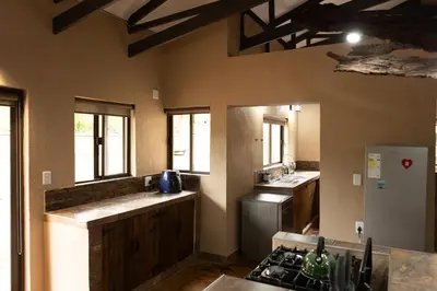 a kitchen with a stove and a refrigerator at Wonderviews Hedgehog in Marloth Park