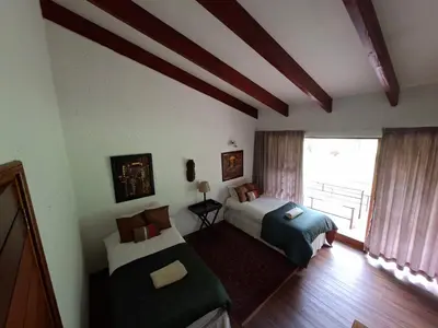 a bedroom with two beds and a large window at Naledi-Africa in Centurion