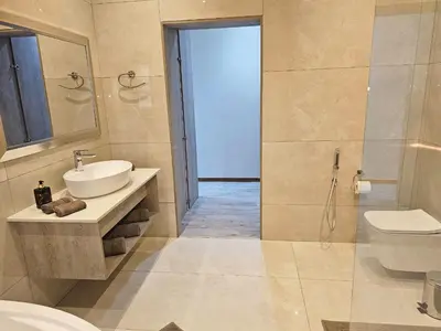 a bathroom with a sink and a toilet and a shower at Palms Erasmia in Centurion