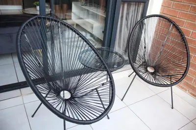 two metal chairs sitting next to a window at The Blyde Crystal Lagoon Exclusive Apartment in Pretoria