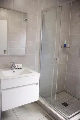 a bathroom with a shower and a sink at The Blyde Crystal Lagoon Exclusive Apartment in Pretoria