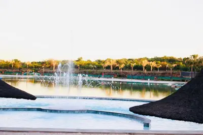 a fountain in the middle of a body of water at The Blyde Crystal Lagoon Exclusive Apartment in Pretoria