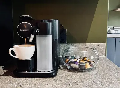 a coffee maker on a counter with a cup of coffee at Rhula Villa in Hoedspruit