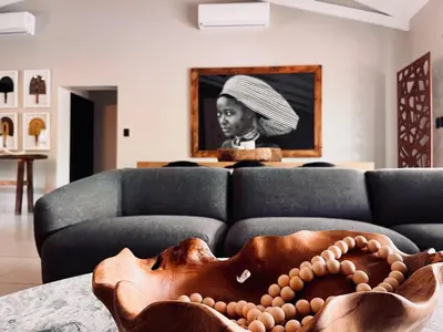 a living room with a couch with a bowl on a table at Rhula Villa in Hoedspruit