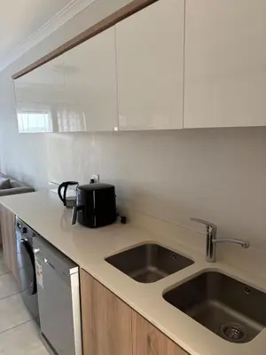 a kitchen with a sink and a microwave at The Modern Stay At The Blyde in Pretoria