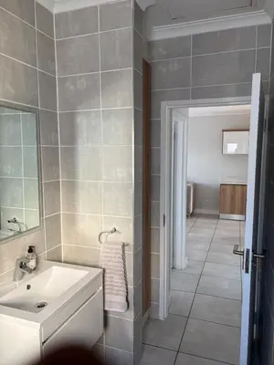 a bathroom with a white sink and a mirror at The Modern Stay At The Blyde in Pretoria