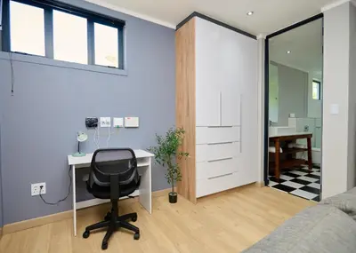 a home office with a desk and a chair at Brooklyn Modern Apartment Near Hatfield & Menlyn in Pretoria