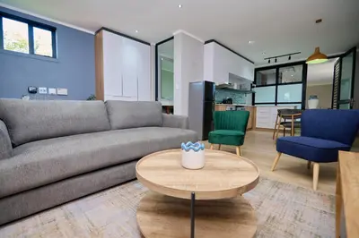 a living room with a couch and a table at Brooklyn Modern Apartment Near Hatfield & Menlyn in Pretoria