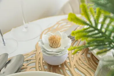 a table with a white vase with a flower on it at GreenPark Home A chic retreat and peaceful home in Boksburg