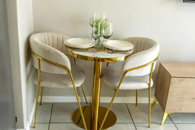 a dining room table with two chairs and a gold table at GreenPark Home A chic retreat and peaceful home in Boksburg