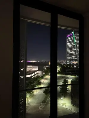 a view of a city at night from a window at Elegant AirConditioned Neria at Ellipse Waterfall in Midrand