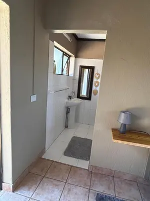 a bathroom with a toilet and a sink at Dorpsrus in Bela-Bela