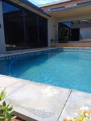 a swimming pool in front of a house at the Host at Bingos House in Thohoyandou