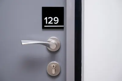 a close up of a door with a clock on it at 129 at Menlyn Maine in Pretoria