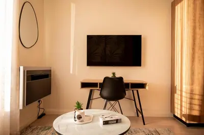 a living room with a table and a desk at 129 at Menlyn Maine in Pretoria