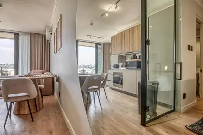 a kitchen and dining room with a table and chairs at Golden Sunrise Suite at The Ellipse Waterfall in Midrand