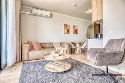 a living room with a couch and a table at Golden Sunrise Suite at The Ellipse Waterfall in Midrand