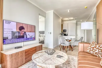 a living room with a large flat screen tv at Ellipse Waterfall Luxe Retreat in Midrand