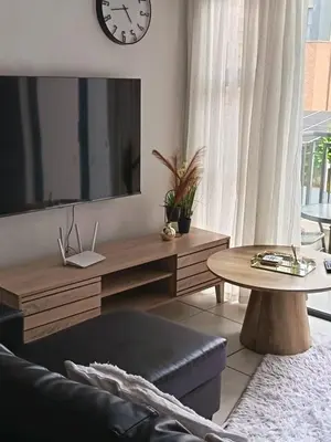 a living room with a large tv and a table at The Blyde Cozy 1-Bedroom in Pretoria