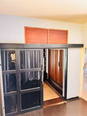 a room with two sliding glass doors in a house at Bophelong Guest House in Witbank
