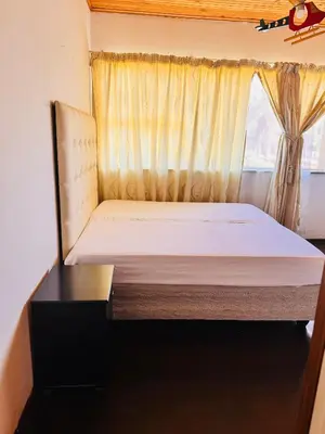 a bed in a small room with a window at Bophelong Guest House in Witbank