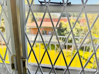 a window with a view of a green field at Bophelong Guest House in Witbank
