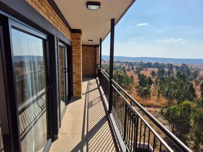a balcony with a view of the mountains at One at Corridor in Witbank