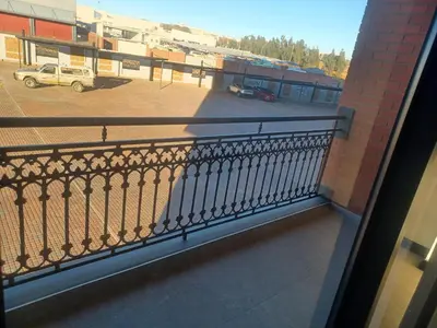 a balcony with a view of a parking lot at One at Corridor in Witbank