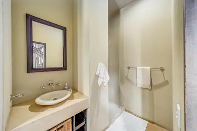 a bathroom with a sink and a mirror at Bushveld Haven - Golf, Spa & Safari Lodge Stay in Warmbaths