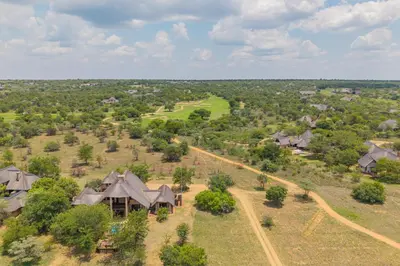 an aerial view of a house with a golf course at Bushveld Haven - Golf, Spa & Safari Lodge Stay in Warmbaths
