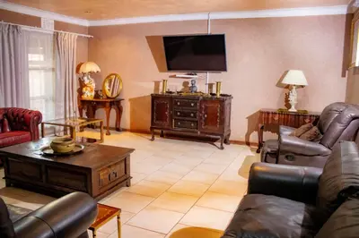 a living room with a couch and a tv at Travel Shift Accommodation in Northam