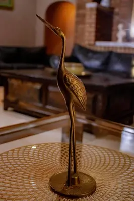 a bronze statue of a bird on a table at Travel Shift Accommodation in Northam