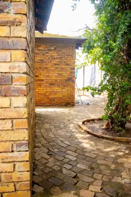 a brick building with a stone walkway next to a building at Travel Shift Accommodation in Northam