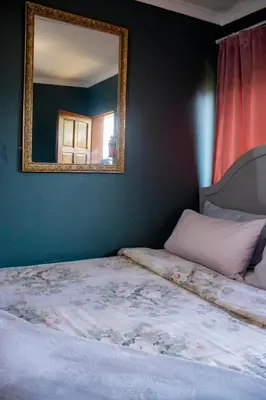 a bedroom with a bed with a mirror on the wall at Travel Shift Accommodation in Northam