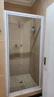 a shower with a glass door in a bathroom at Elegant Self-Catering Witbank, 6 min Highveld Mall in Witbank
