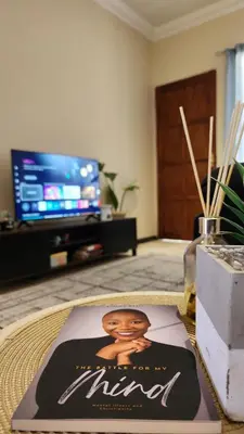 a living room with a picture of a man on a table at Elegant Self-Catering Witbank, 6 min Highveld Mall in Witbank