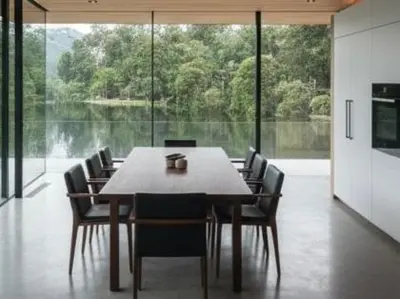 a dining room with a table and chairs and a large window at De Holiday Home in Haenertsburg