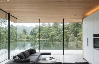 a living room with a couch and a large window at De Holiday Home in Haenertsburg